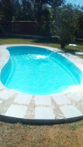 a large blue swimming pool in a yard at Real Campestre La Antigua 