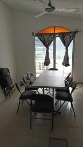 a table and chairs in a room with a window at Real Campestre La Antigua 