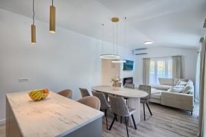 a kitchen and living room with a table and chairs at Relax penthouse private jacuzzi Split area in Žrnovnica +38 photos