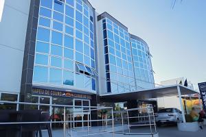 a large glass building with a car parked in front at Luxo Frente Mar | Nobile #220 in Tambaú