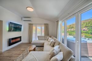 a living room with a couch and a fireplace at Relax penthouse private jacuzzi Split area in Žrnovnica