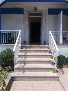 a staircase leading to a house with purple flowers at Villa Riviera in Stavros