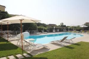 a swimming pool with lounge chairs and an umbrella at Al Mare da Francesca in Olbia