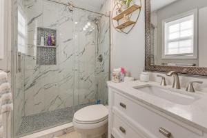 a bathroom with a shower and a toilet and a sink at Bluffton Getaway with Fenced Yard 7 Mi to Beach! in Bluffton +24 photos