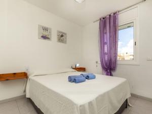 a bedroom with a bed with two towels on it at Apartment Bahia by Interhome in Cunit