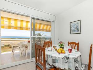 a dining room with a table and a view of the ocean at Apartment Bahia by Interhome in Cunit +13 photos
