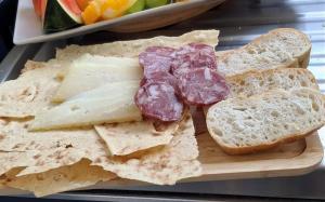 a tray with bread and cheese and meats on it at Al Mare da Francesca in Olbia