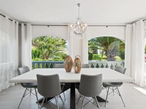 a dining room with a white table and chairs at Holiday Home Los Limoneros de Moraira by Interhome in Moraira