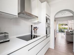 a kitchen with white cabinets and a counter top at Holiday Home Los Limoneros de Moraira by Interhome in Moraira