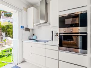 a kitchen with white cabinets and a stainless steel oven at Holiday Home Los Limoneros de Moraira by Interhome in Moraira +23 photos