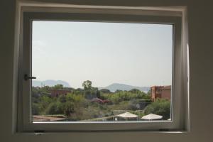 a window with a view of a city at Al Mare da Francesca in Olbia