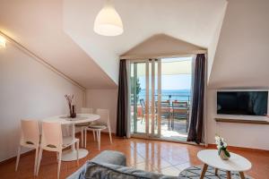 a living room with a couch and a table at Apartments Villa SanMarino in Pakoštane
