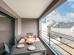 a balcony with a table with food on it at Apartment Chasse Marée by Interhome in Quiberon