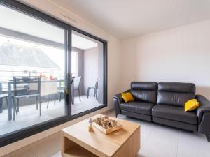 a living room with a couch and a table at Apartment Chasse Marée by Interhome in Quiberon