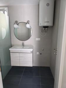 a bathroom with a sink and a mirror at Bright & Bloom Luxury Studios in Hanioti +19 photos