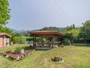 a gazebo with a picnic table in a yard at Apartment Titta by Interhome in Casarza Ligure