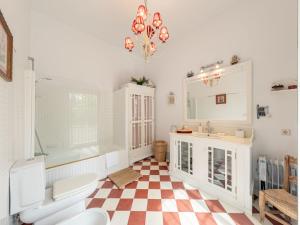 a bathroom with a tub and a toilet and a sink at Villa Las Codornices-1 by Interhome in Sanlúcar la Mayor