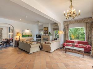 a living room filled with furniture and a chandelier at Villa Las Codornices-1 by Interhome in Sanlúcar la Mayor +41 photos