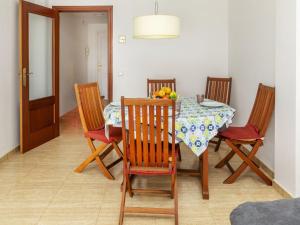 a dining room with a table and four chairs at Apartment Ronda Creixell by Interhome in Creixell