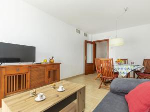 a living room with a couch and a table at Apartment Ronda Creixell by Interhome in Creixell