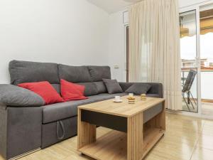 a living room with a couch and a coffee table at Apartment Ronda Creixell by Interhome in Creixell +16 photos