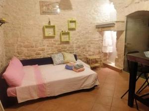 a bedroom with a bed in a brick wall at Studio in Giovinazzo - Apulien 54437 in Giovinazzo