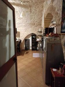 a kitchen with a stove and a stone wall at Studio in Giovinazzo - Apulien 54437 in Giovinazzo
