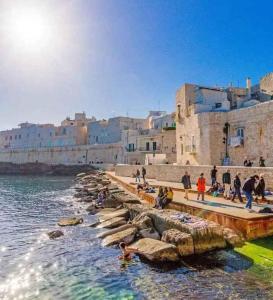 a group of people standing on a dock in the water at Studio in Giovinazzo - Apulien 54437 in Giovinazzo