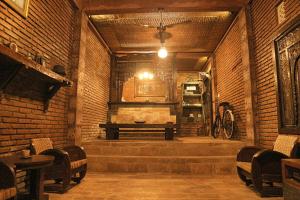 a room with a bench in a brick wall at Din House Room Classic jimbaran Bali in Jimbaran