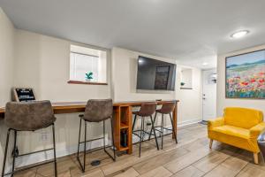 a bar in a room with stools at Jersey City Retreat w Private Backyard Bonfire Near NYC in Jersey City