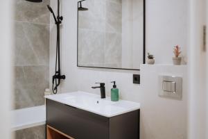 a bathroom with a sink and a mirror at NEW 2BR Near Rîșcani Park in Chişinău +44 photos