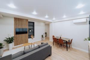 a living room with a couch and a table at NEW 2BR Near Rîșcani Park in Chişinău