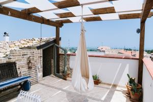 a hammock on the balcony of a house at Villa Adriatica - Character Home, Costa dei Trabocchi in Villalfonsina