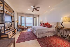 a bedroom with a bed and a flat screen tv at Luxurious Penthouse at Vistamar! Golf - Beachclub in La Paz