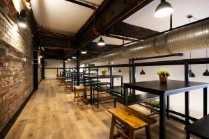 a row of tables and benches in a room at Samesun Vancouver in Vancouver