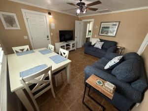 a living room with a table and a couch at Palm Haven Beach Side Villa in Holmes Beach