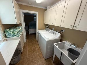 a small kitchen with a washing machine and a sink at Palm Haven Beach Side Villa in Holmes Beach +15 photos
