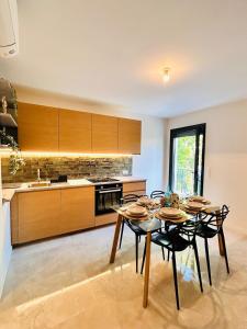 Coliving - Private Shower - Bfast & Terrace Dining في كاجنيس سور مير: مطبخ مع طاولة وكراسي في الغرفة