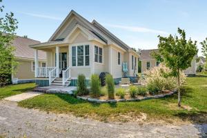 a house with a porch and a yard at The Sparrow - 32 Meadow View in Cherry Valley