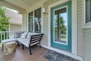 a porch with a blue door and a bench at The Sparrow - 32 Meadow View in Cherry Valley