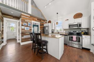 a kitchen with white cabinets and a counter top at The Sparrow - 32 Meadow View in Cherry Valley