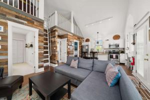 a living room with a couch and a table at The Sparrow - 32 Meadow View in Cherry Valley
