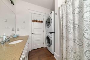 a laundry room with a washer and dryer and a sink at The Sparrow - 32 Meadow View in Cherry Valley +93 photos