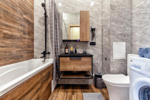 a bathroom with a tub and a toilet and a sink at 1-комнатная квартира Кумисбекова 4, ЖК Altyn Tau in Astana +15 photos