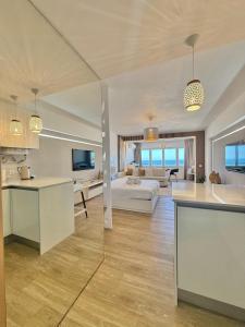 a large living room with a bed and a kitchen at The View Costa Caparica in Costa da Caparica