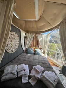 a bedroom with a large bed with three pillows on it at La bulle des coucous in Saint-Hilaire-de-Riez