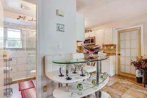Baldwin8 Mi to Long Beach Cozy Apt with Fenced Yard!的配有玻璃桌和淋浴的厨房