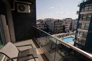 a balcony with two chairs and a view of a city at Ana Derol in Năvodari