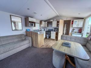 a living room with a couch and a table at Fantastic 6 Berth Caravan At Haven Skegness Holiday Park Ref 88028Hr in Skegness