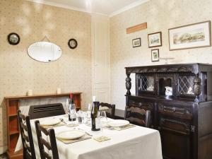 a dining room with a table with a white table cloth at Number 4 in Llandeilo